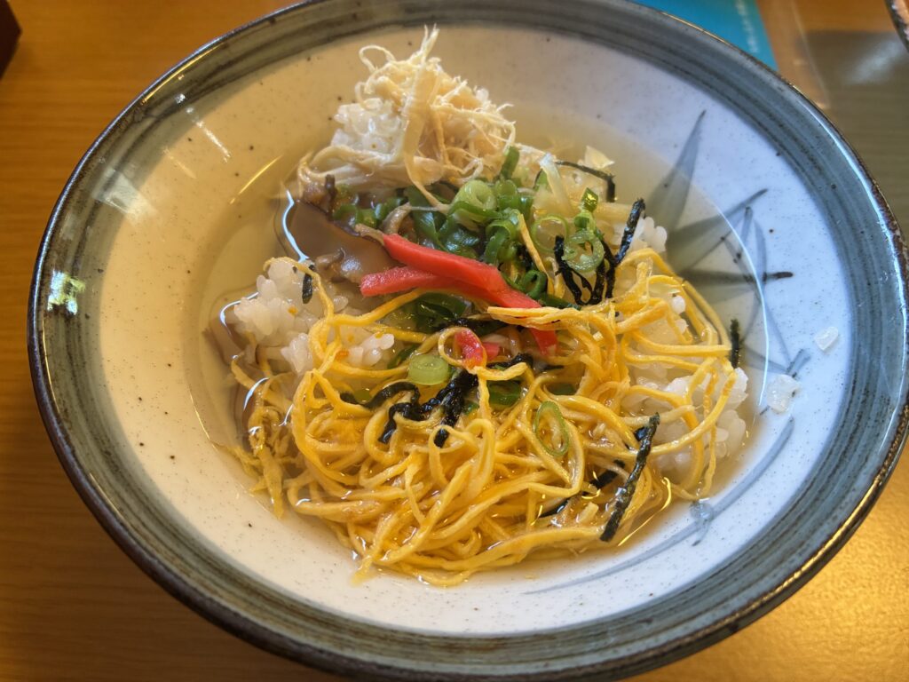 鶏肉や錦糸卵をのせて出汁をかけた奄美の鶏飯